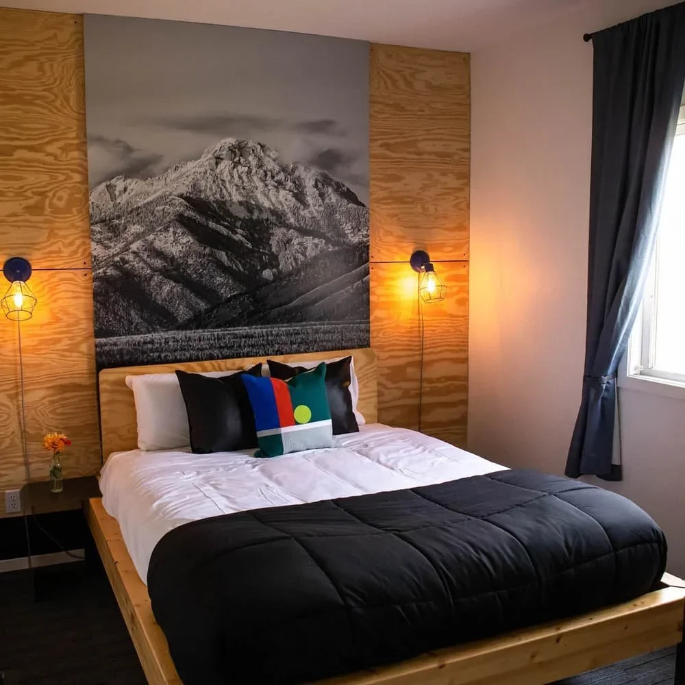 Lodge bedroom with mountain artwork